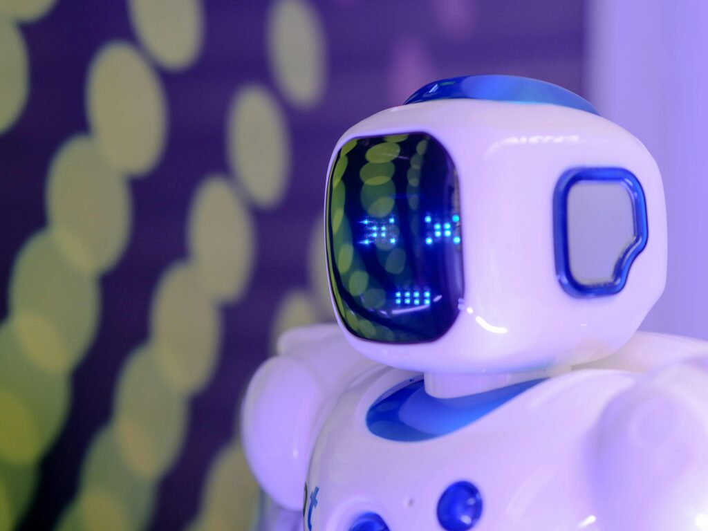 Close-up of a futuristic humanoid robot with a luminescent display in a modern setting.